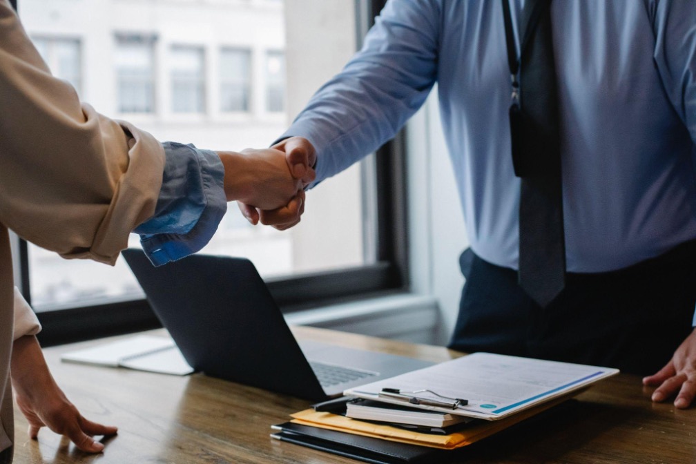 people shaking hands in office Image: Pexels