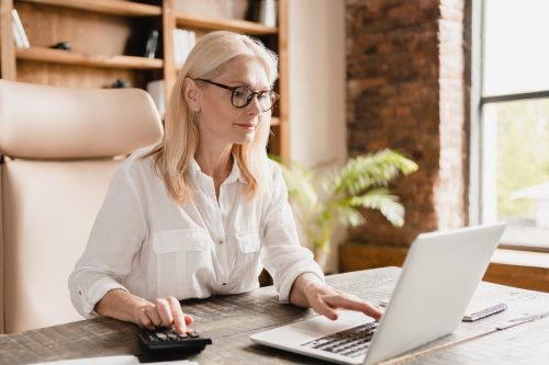 business women with laptop and calculator